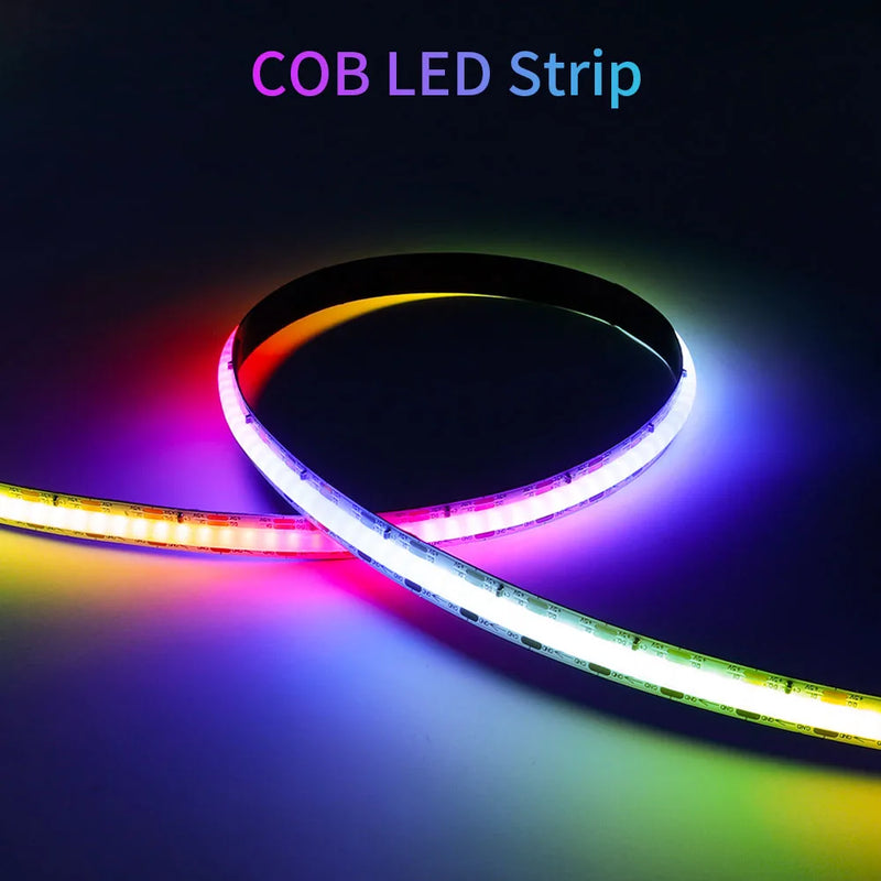 Aurora LED light strip glowing behind a monitor in a dark room